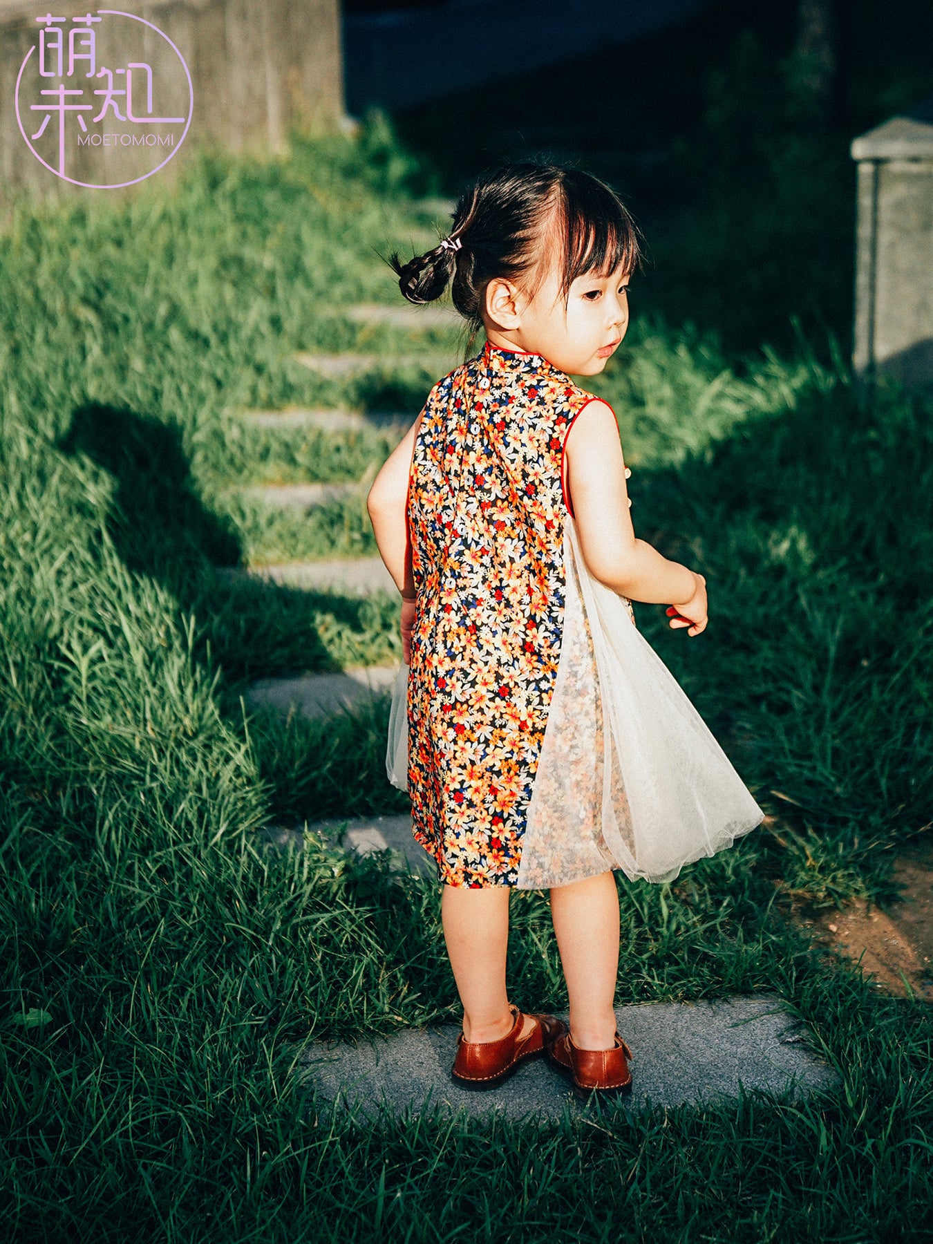 Navy floral qipao-inspired dress styled for a special occasion