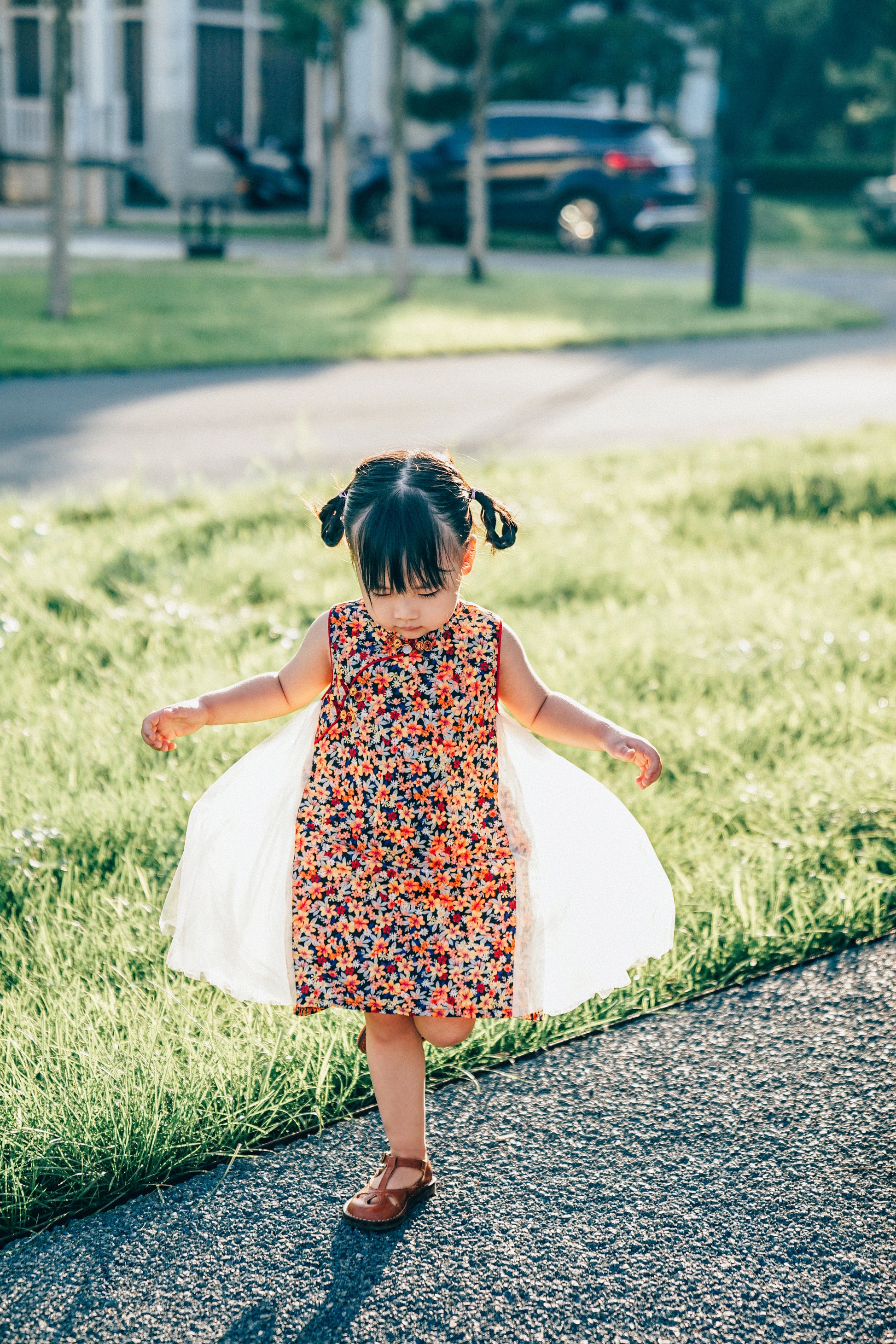Navy floral qipao-inspired girls' tulle dress shown outdoors