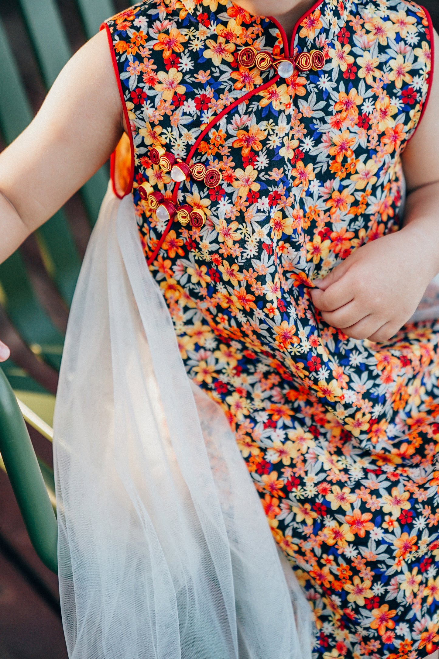 Child wearing a floral qipao-inspired dress for a summer outing