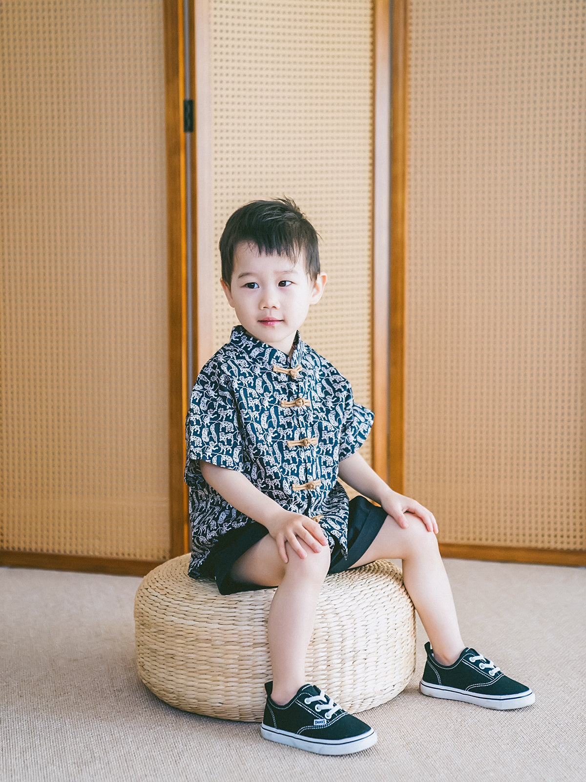 Boy wearing a black-and-white Animal Print Mandarin-collar shirt and shorts set