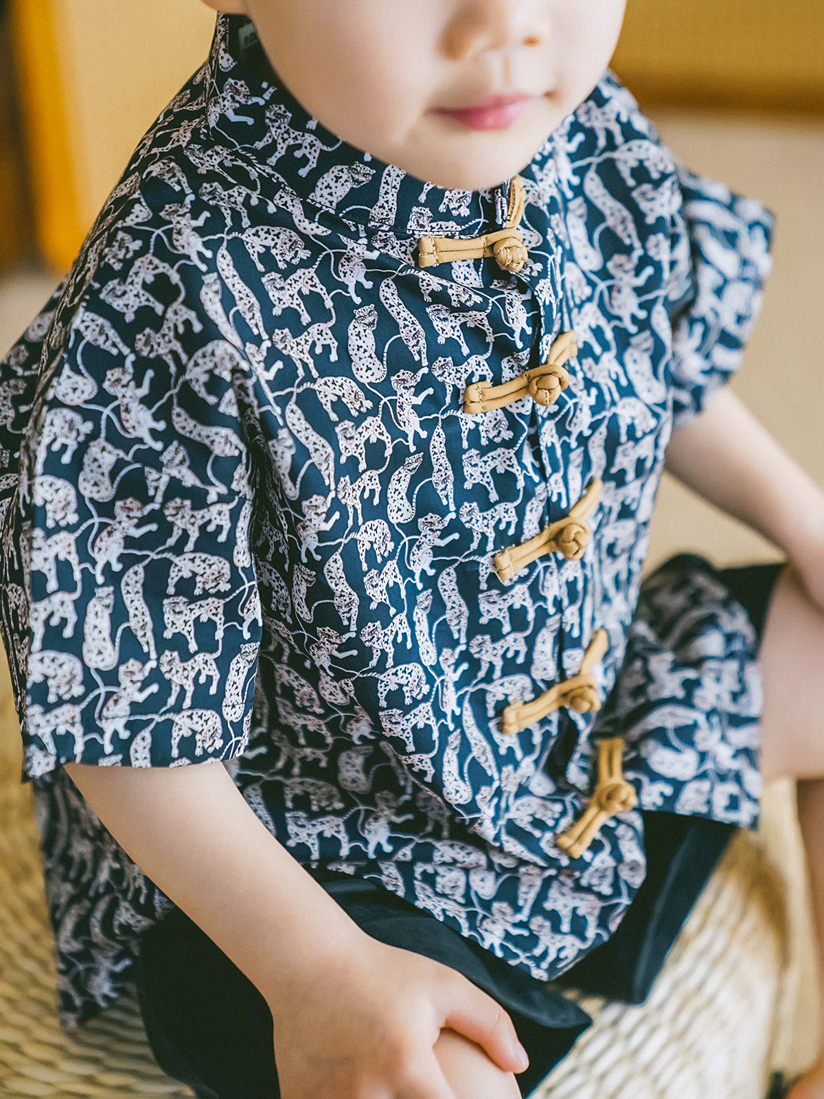 Close-up detail of the Animal Print boys' black-and-white Mandarin-collar shirt and shorts set