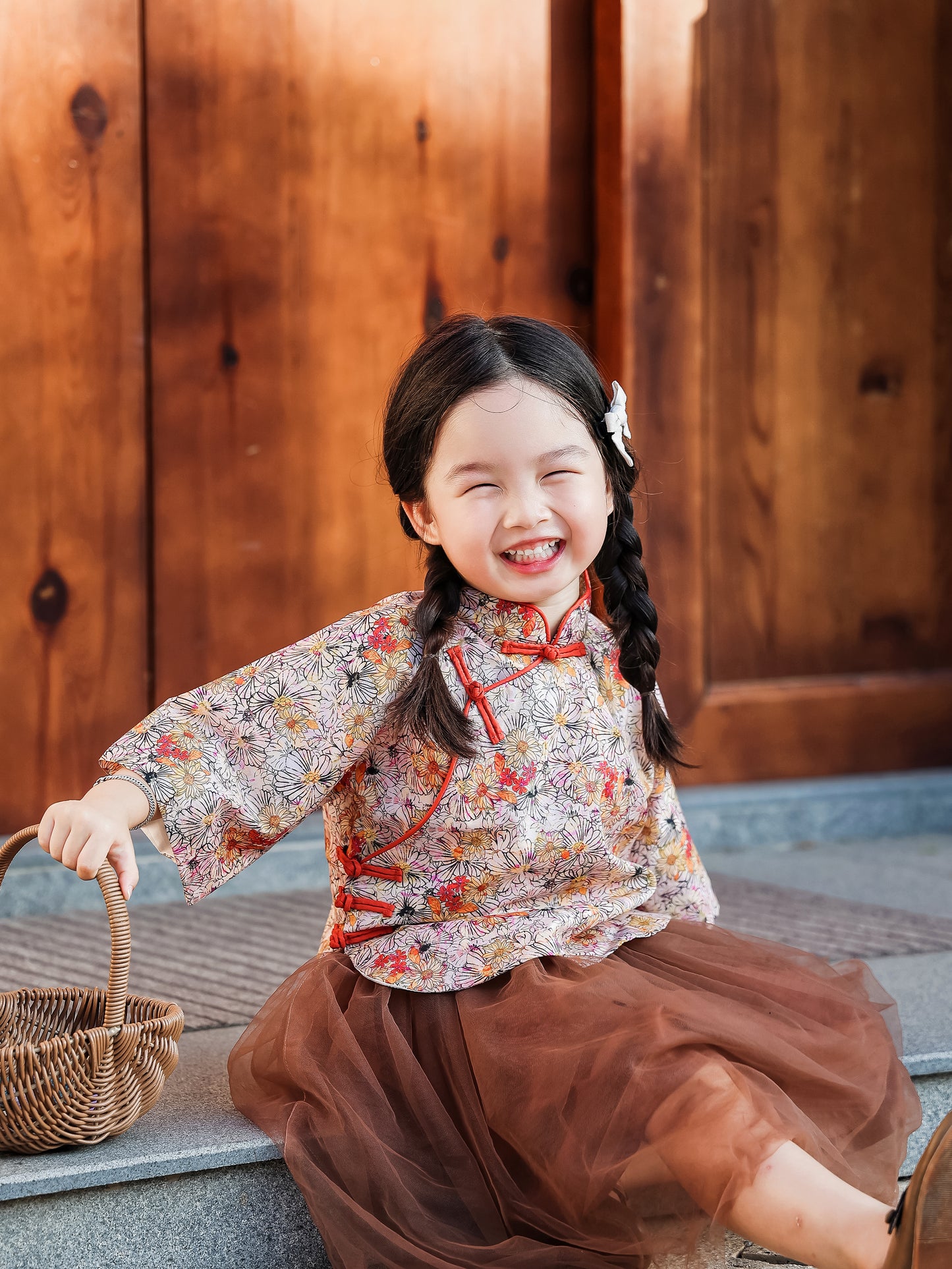 Girl wearing the floral Mandarin top and chestnut tulle skirt set