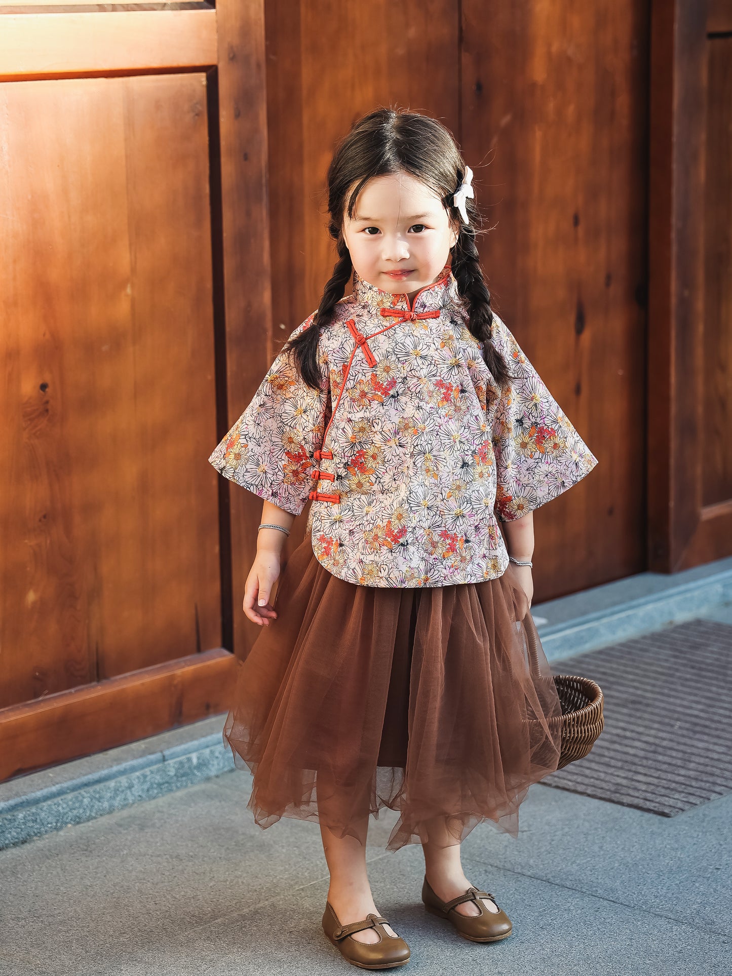Girl standing in the floral Mandarin top and chestnut tulle skirt set