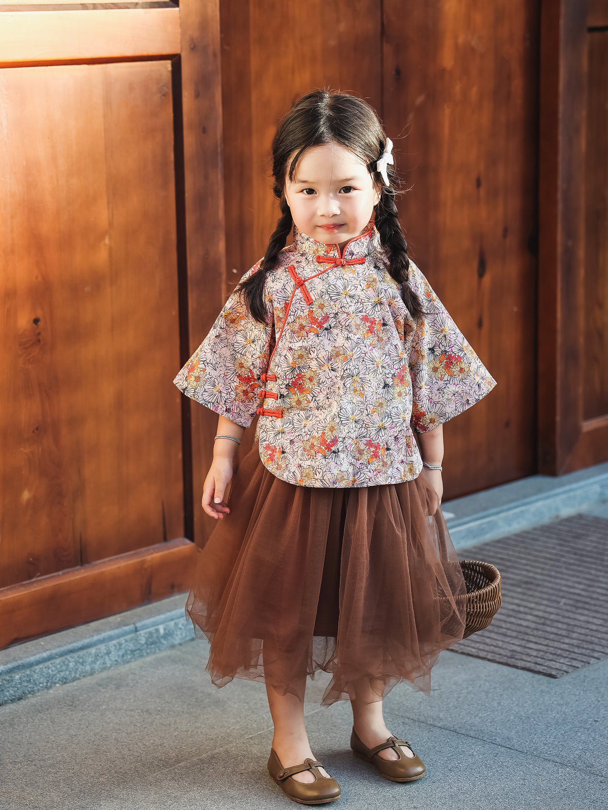 Girl standing in the floral Mandarin top and chestnut tulle skirt set