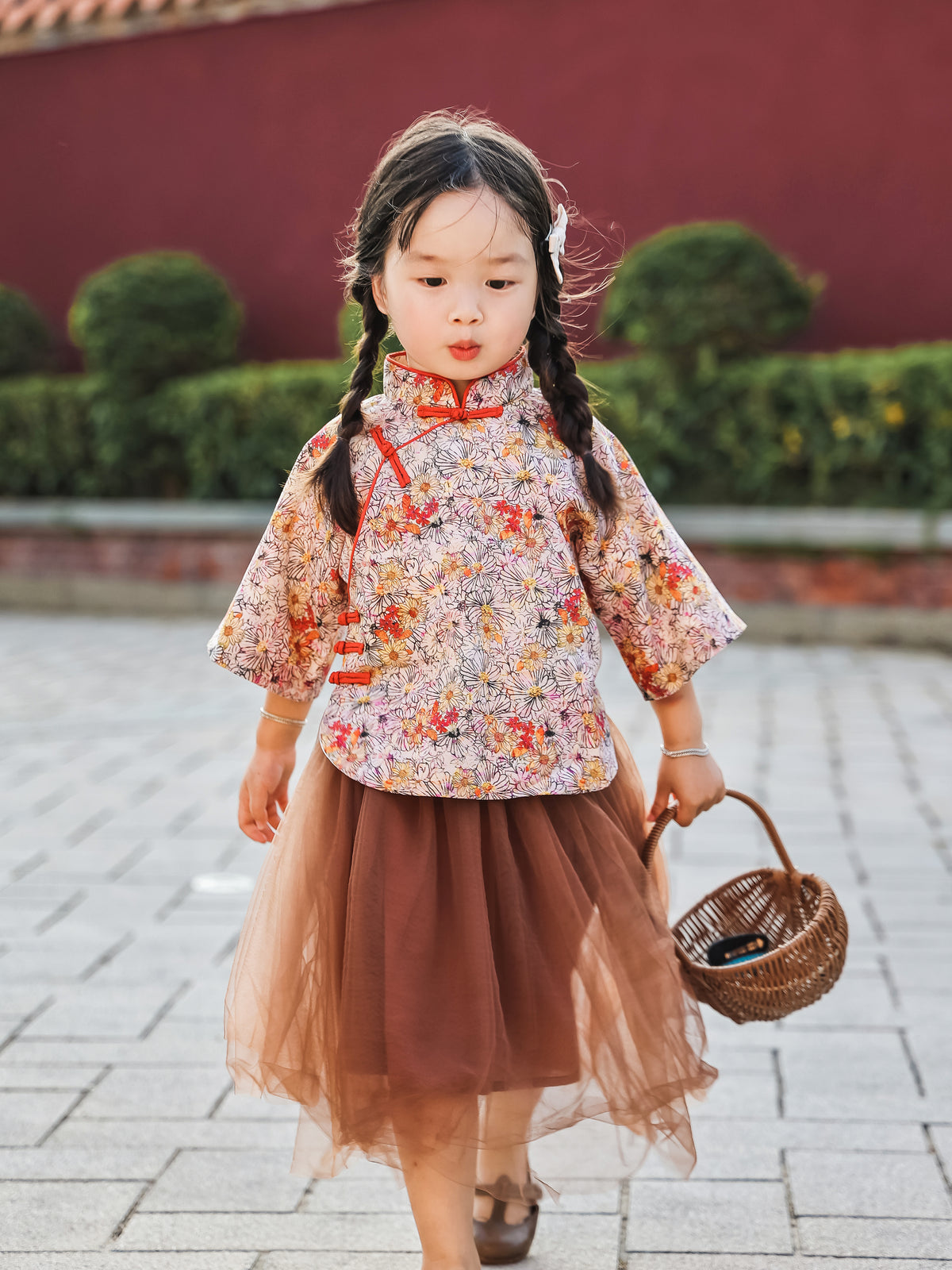 Girl walking in the floral Mandarin top and chestnut tulle skirt set