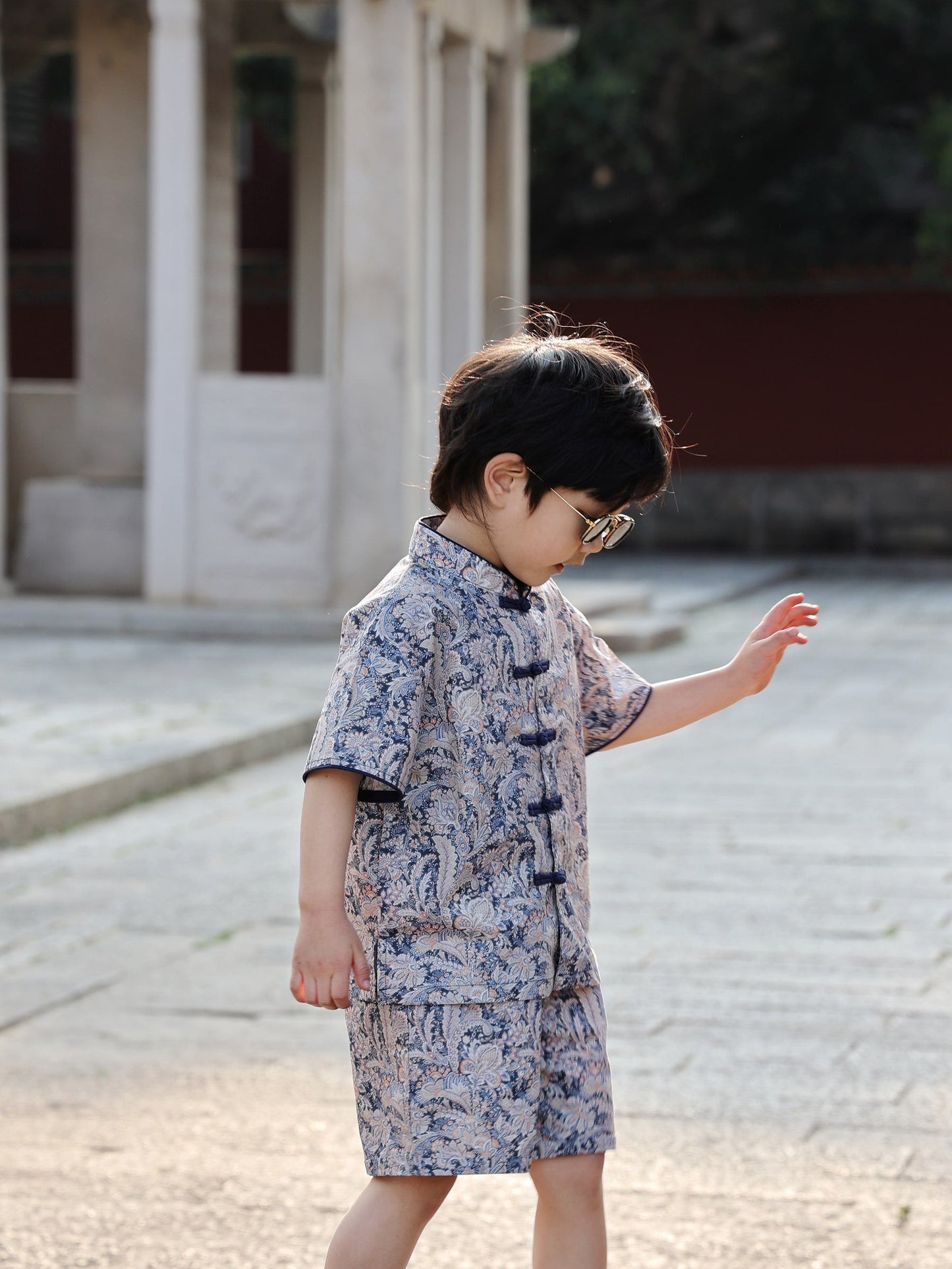 Boy wearing the Blue Paisley Mandarin-collar top and shorts set