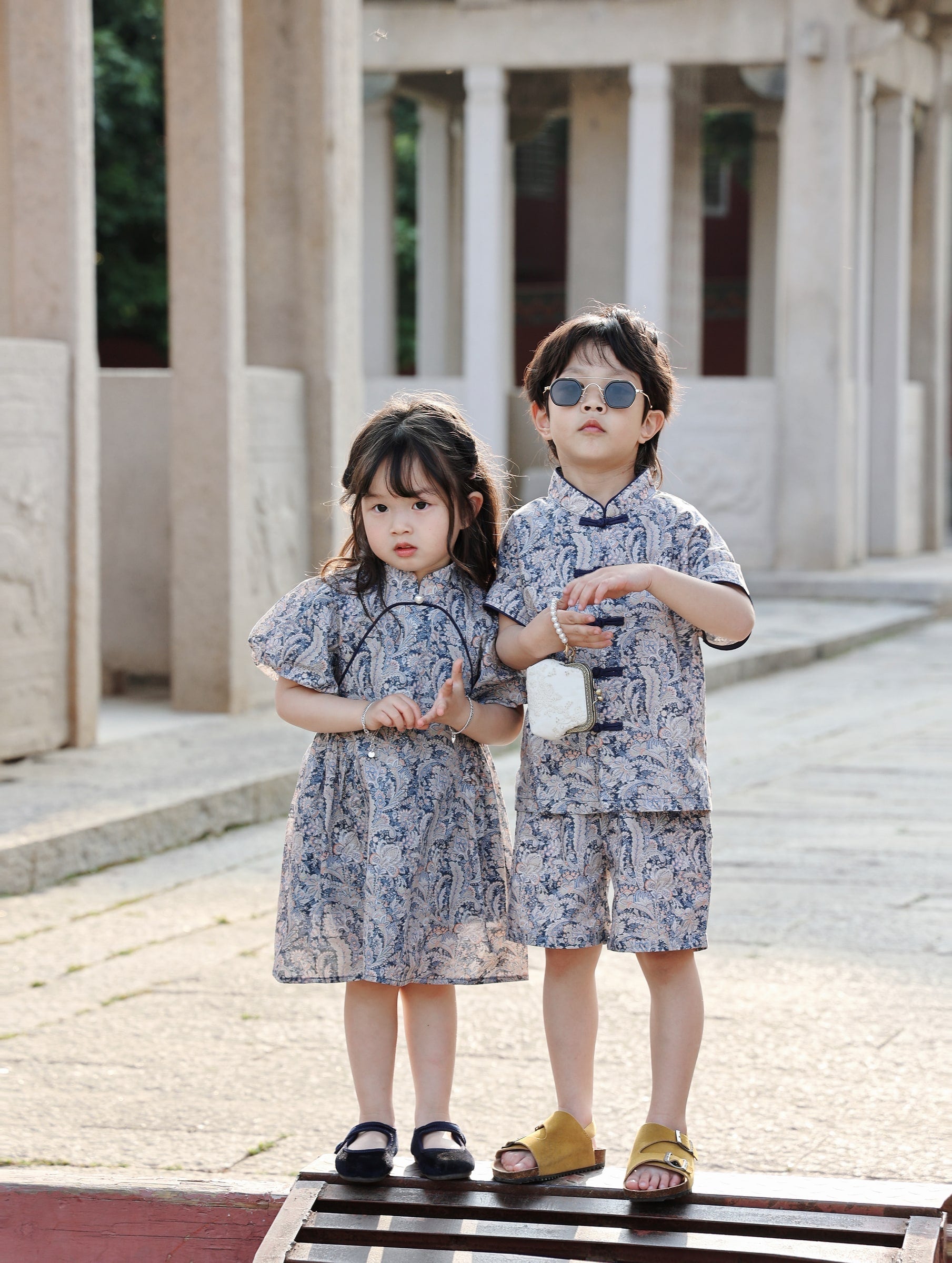 Siblings wearing matching Blue Paisley outfits