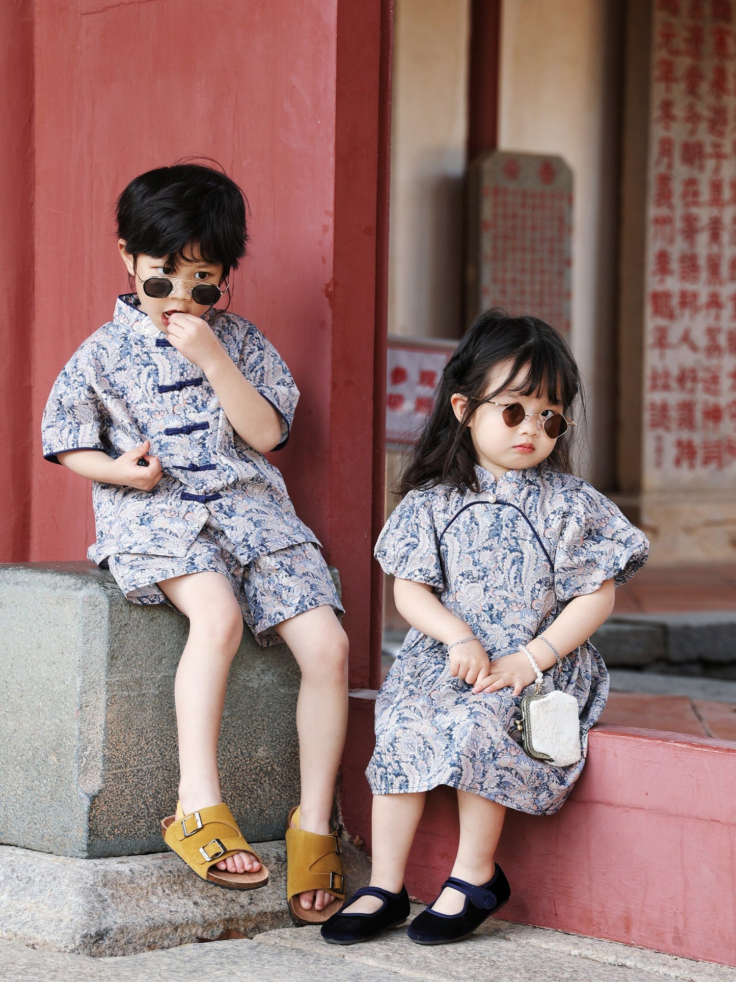 Siblings seated in matching Blue Paisley outfits