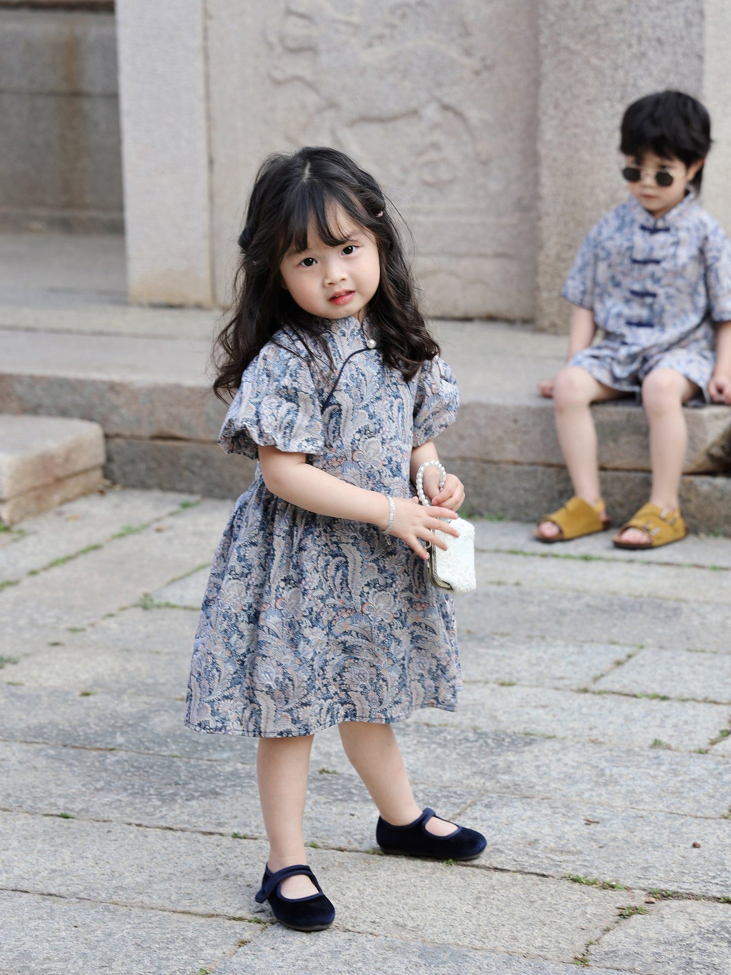 Girl wearing the Blue Paisley puff-sleeve qipao dress outdoors