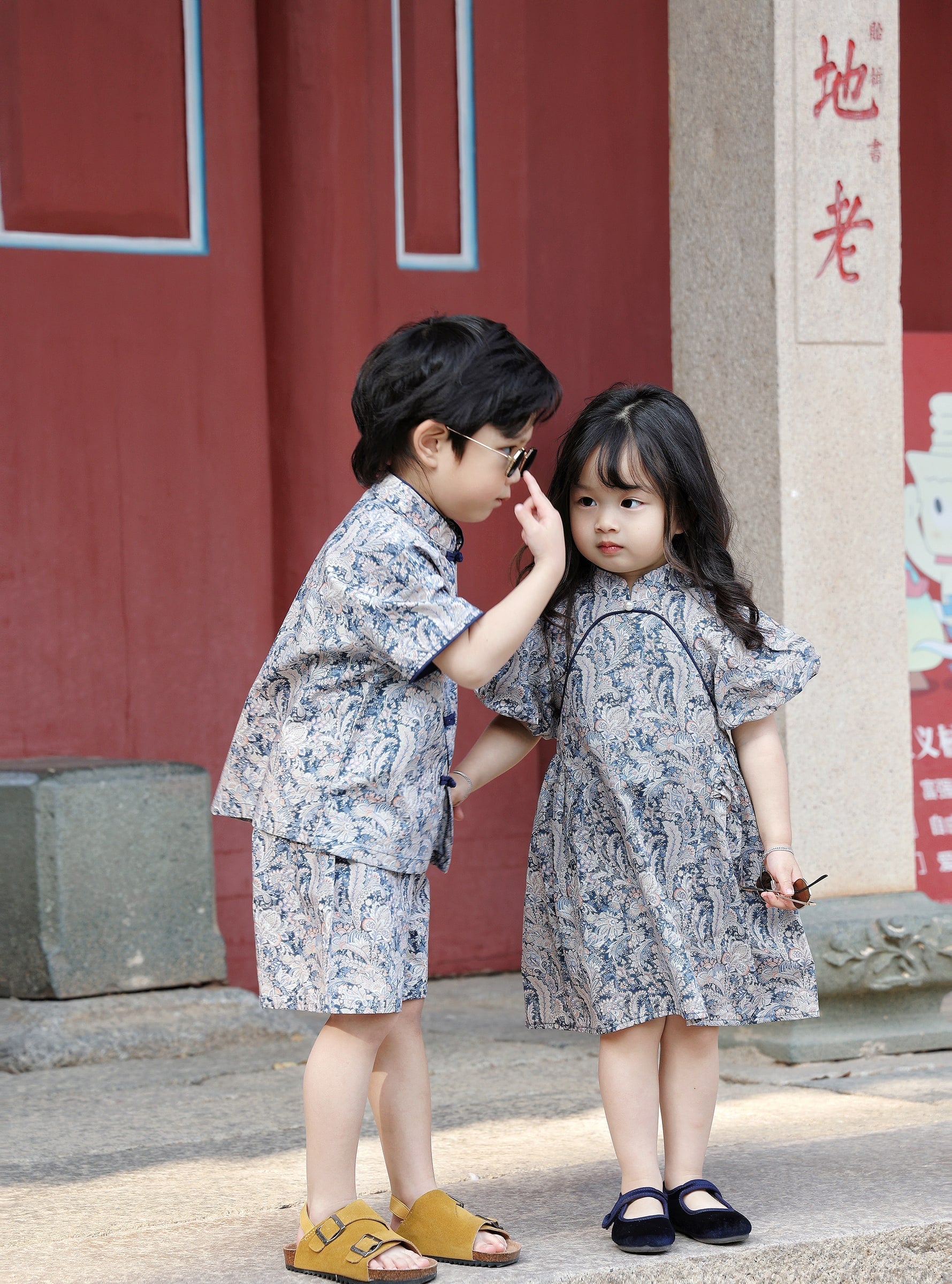 Siblings together in coordinated Blue Paisley outfits