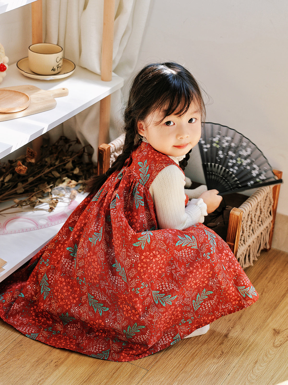Back view of Holiday Bloom red floral dress with white knit layer