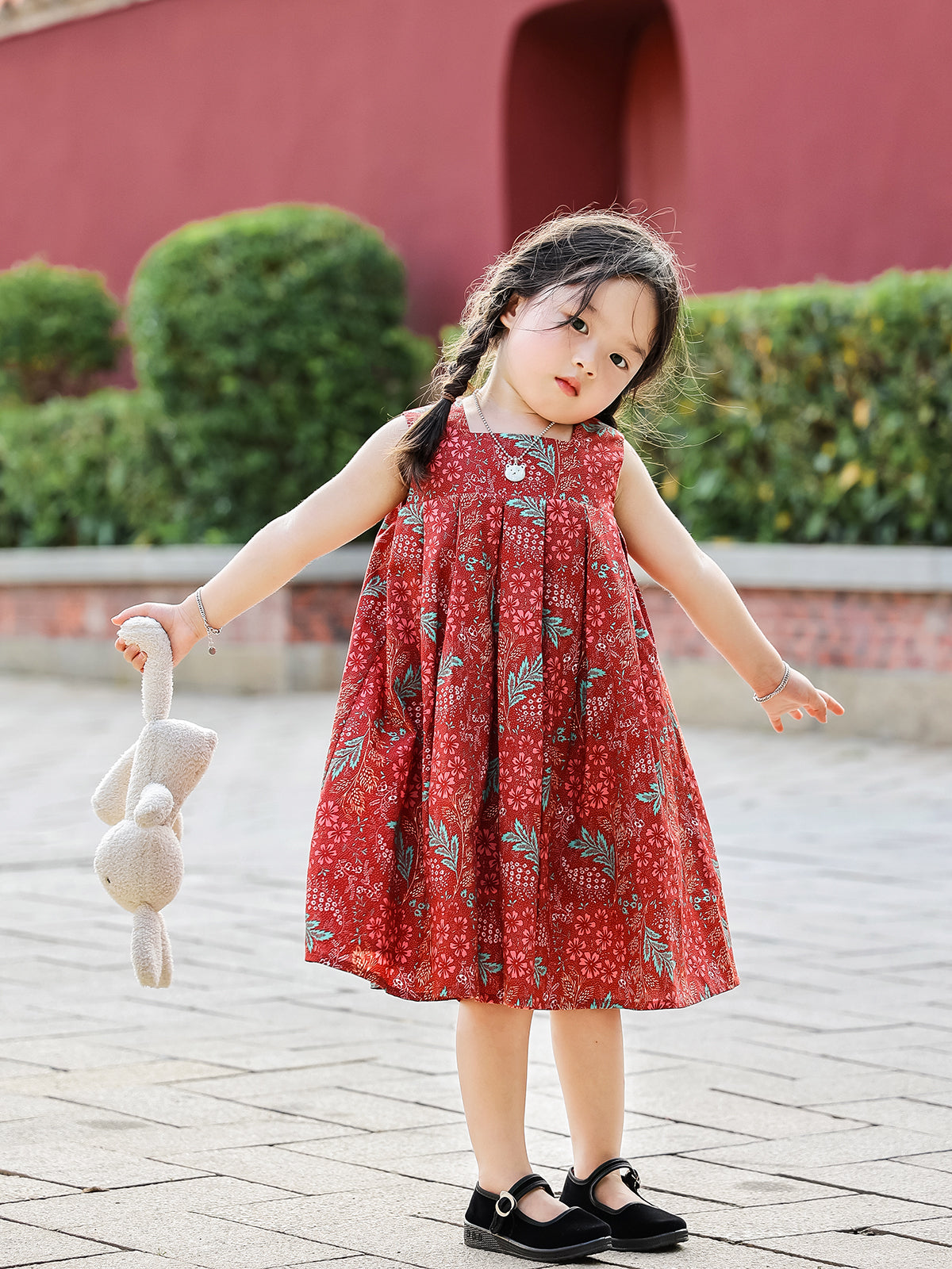 Girl wearing Holiday Bloom red floral dress sleeveless outdoors
