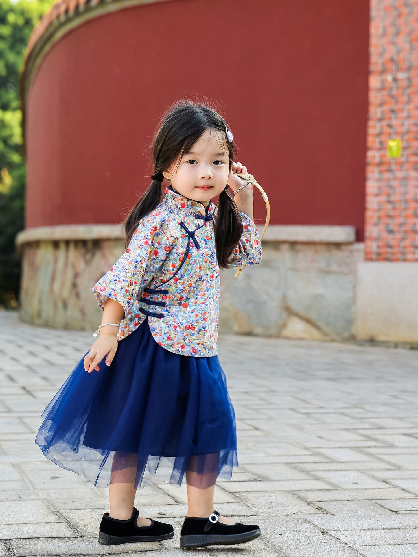 Girl wearing the Indigo Berry floral Mandarin top and navy tulle skirt set