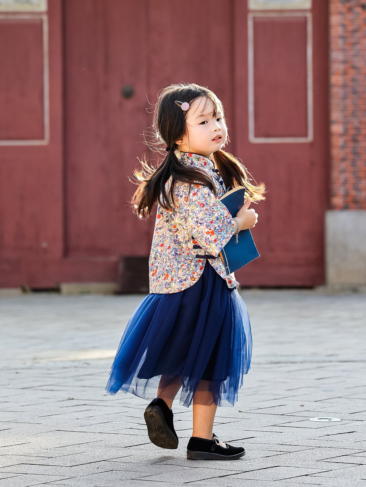 Girl walking in the Indigo Berry floral Mandarin top and navy tulle skirt set