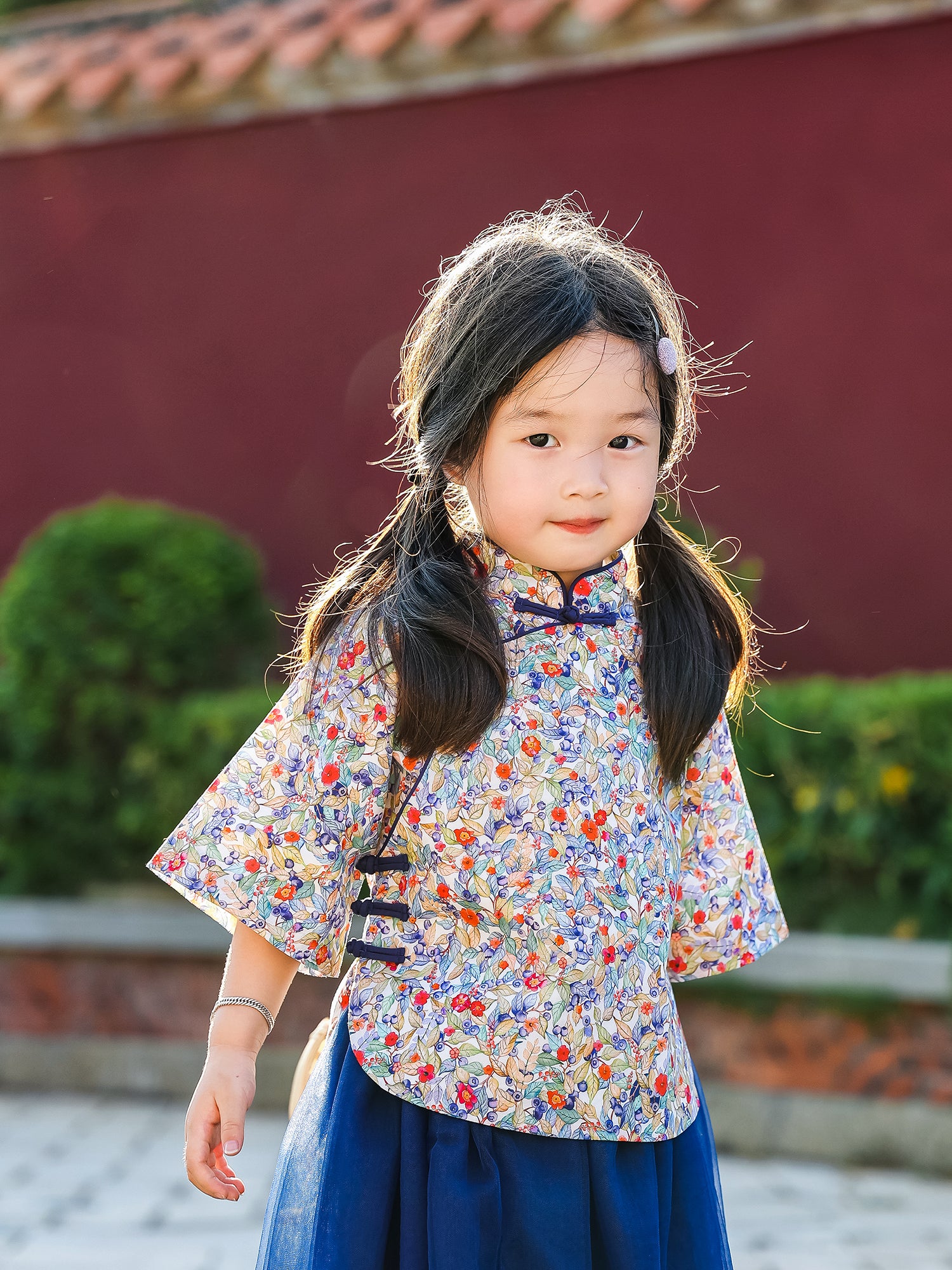 Girl wearing the Indigo Berry floral Mandarin top and navy tulle skirt set