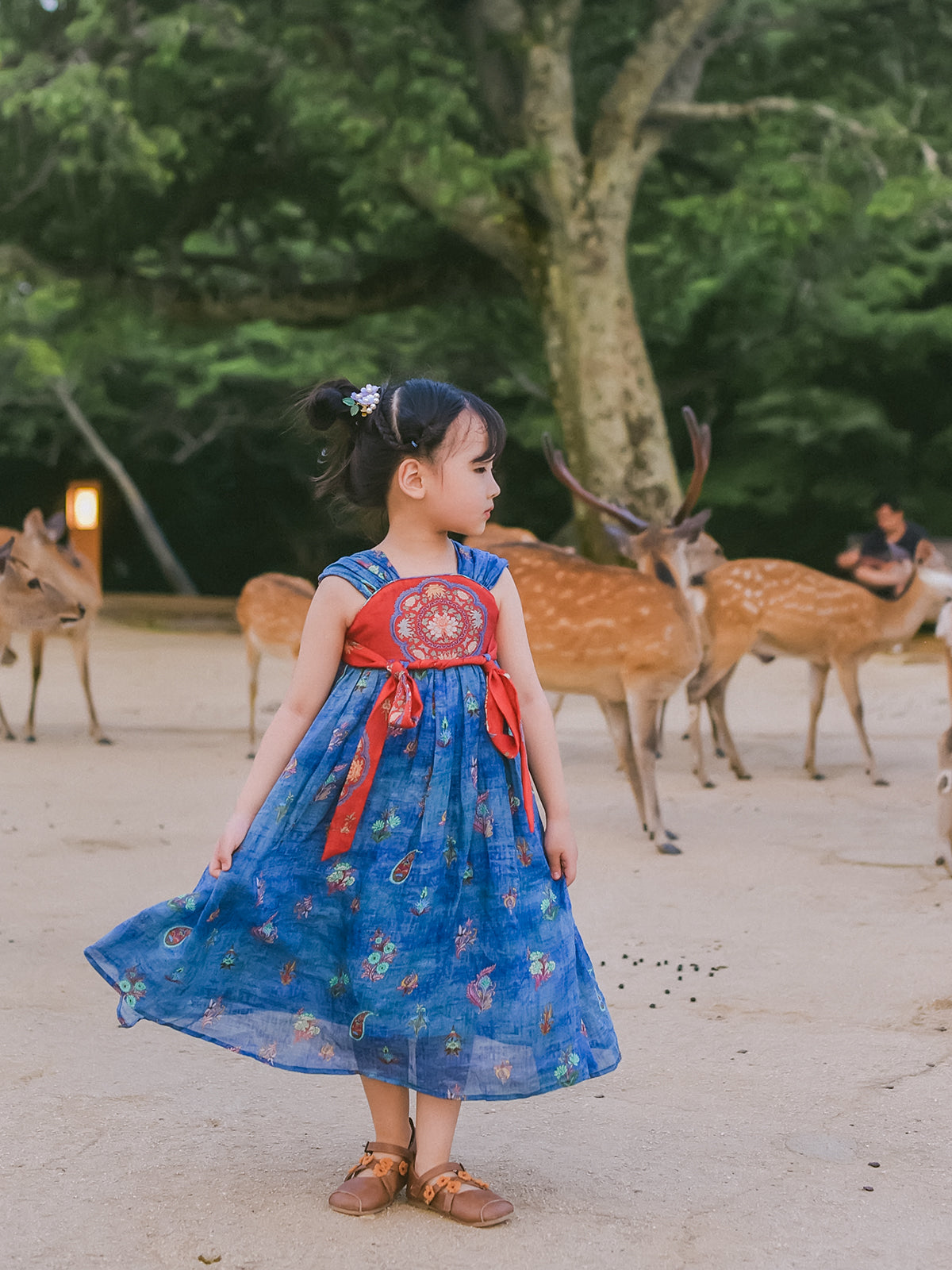 Girl wearing the Indigo Ember blue and vermilion Hanfu-inspired dress, full-length view