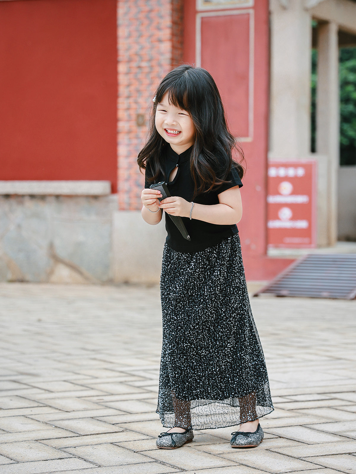 Girl wearing the Little Cloud Mandarin collar tee in Deep Black, full-length view