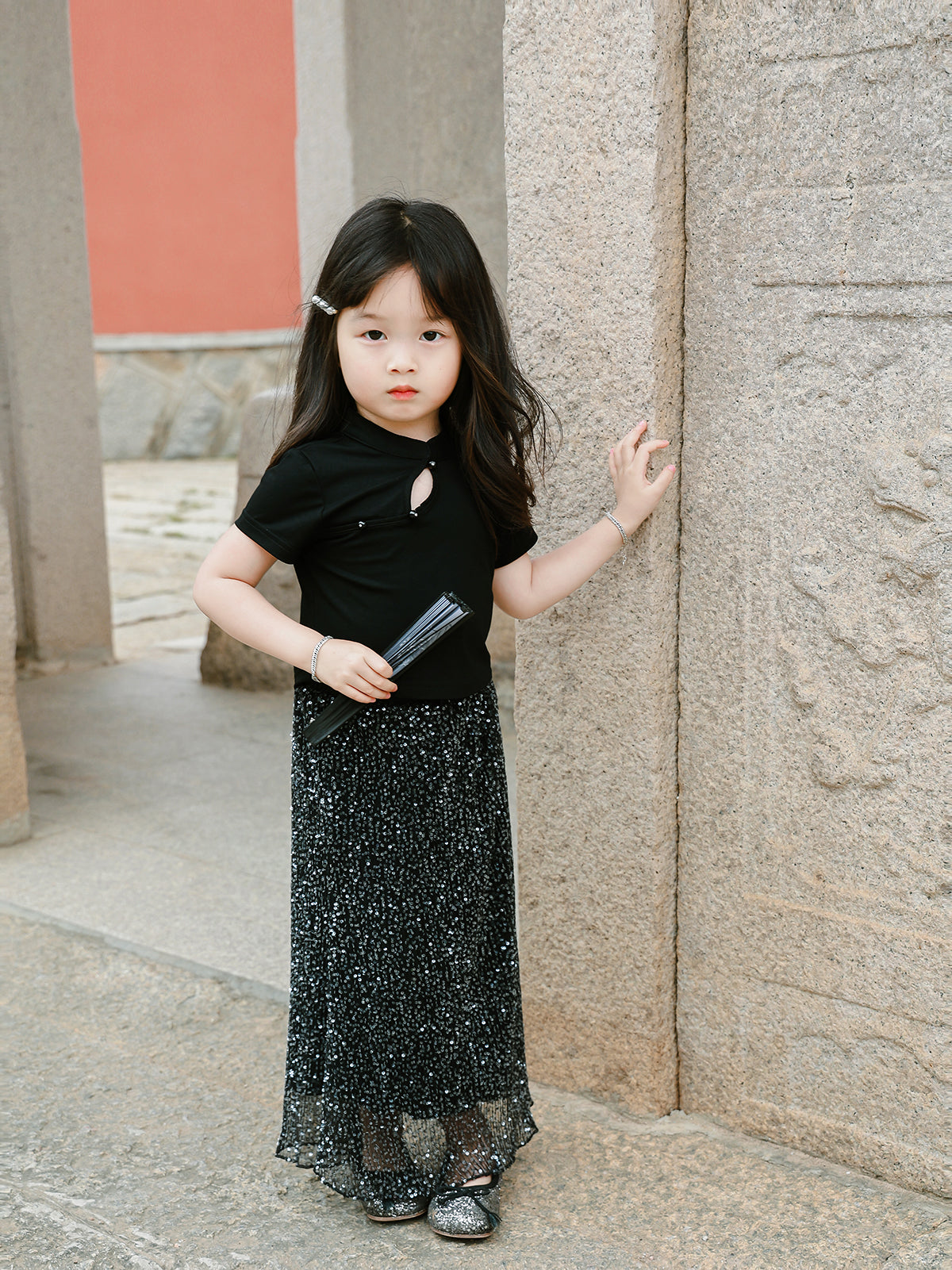 Girl wearing the Little Cloud Mandarin collar tee in Deep Black, front view
