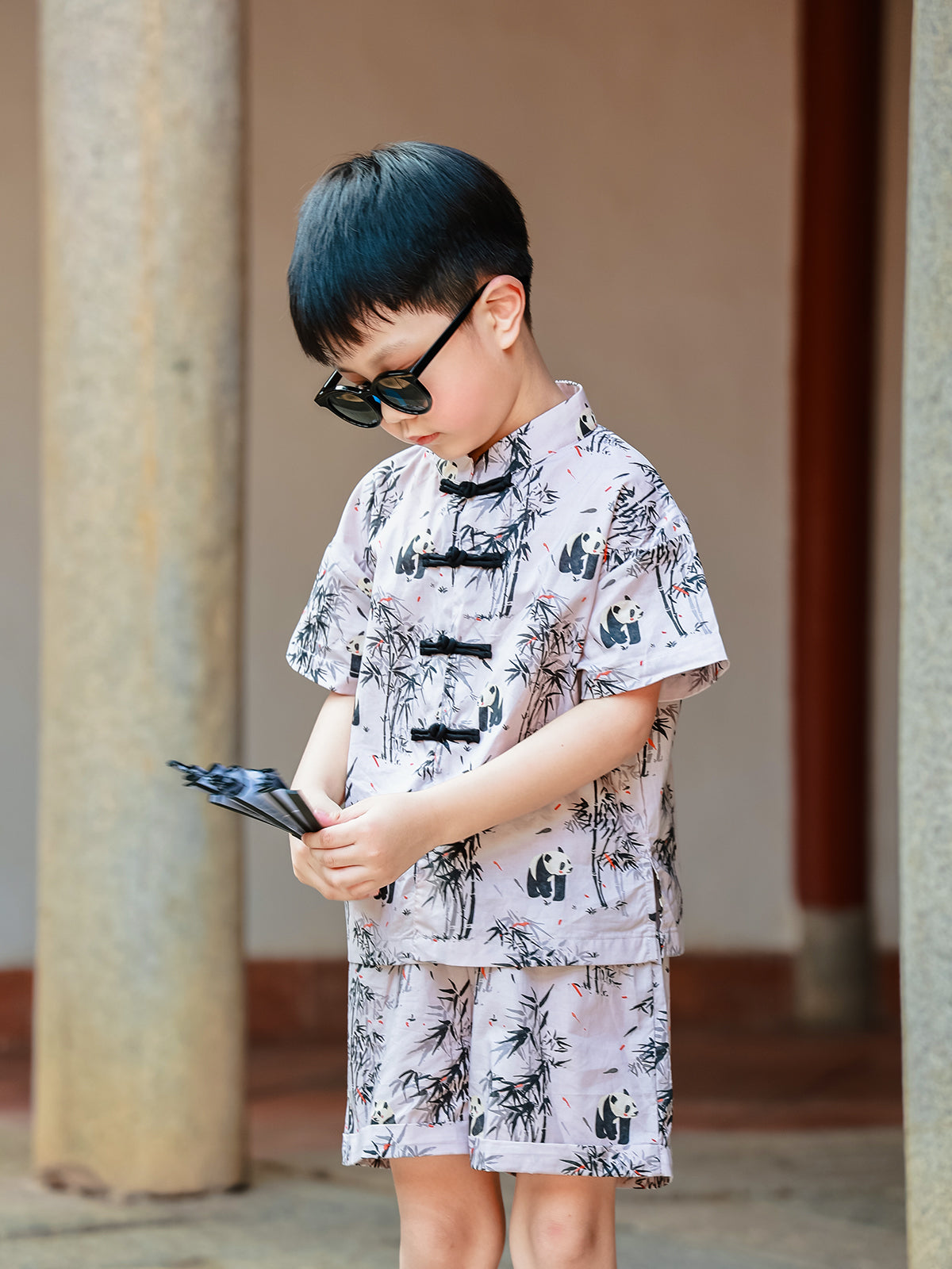Boy wearing Panda Bamboo matching set with fan