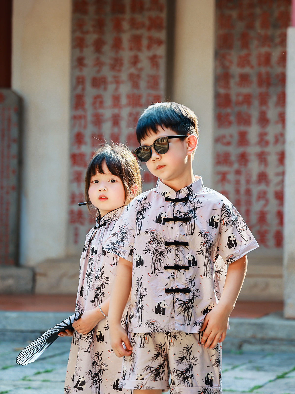 Sibling matching Panda Bamboo outfits portrait