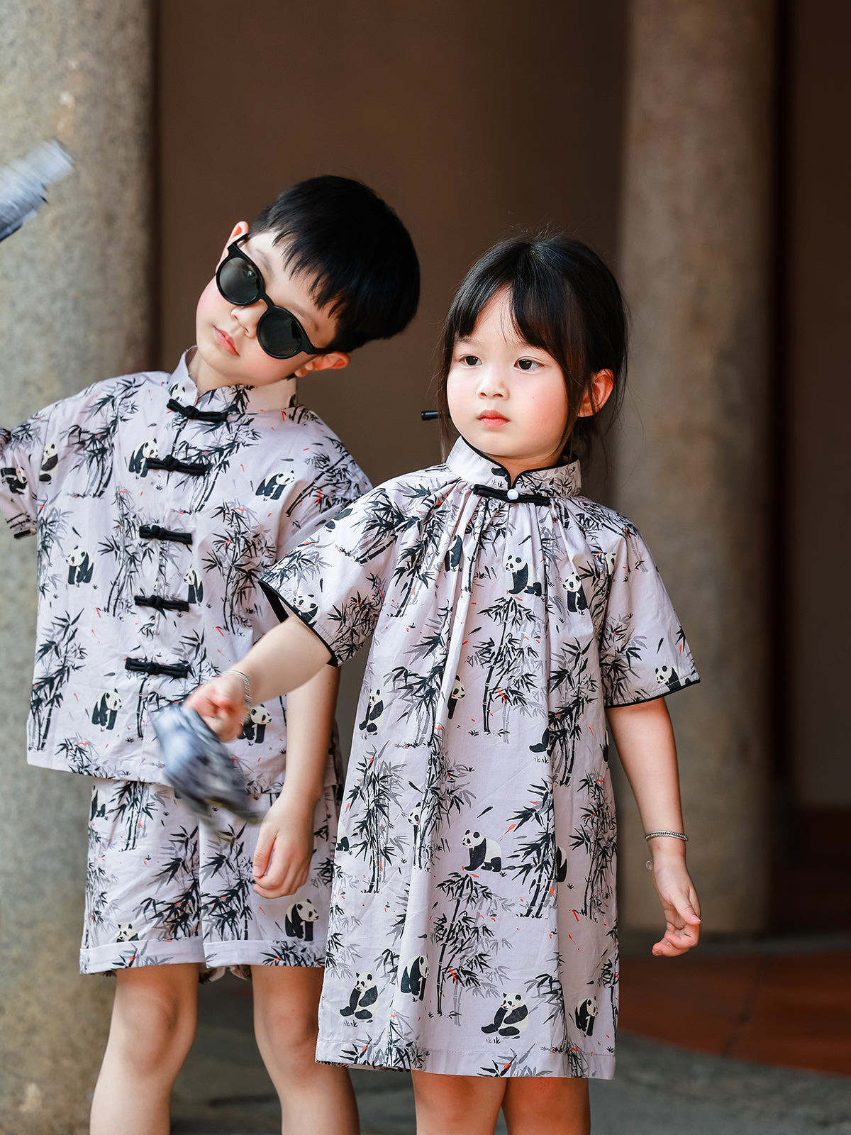 Sibling matching Panda Bamboo outfits portrait
