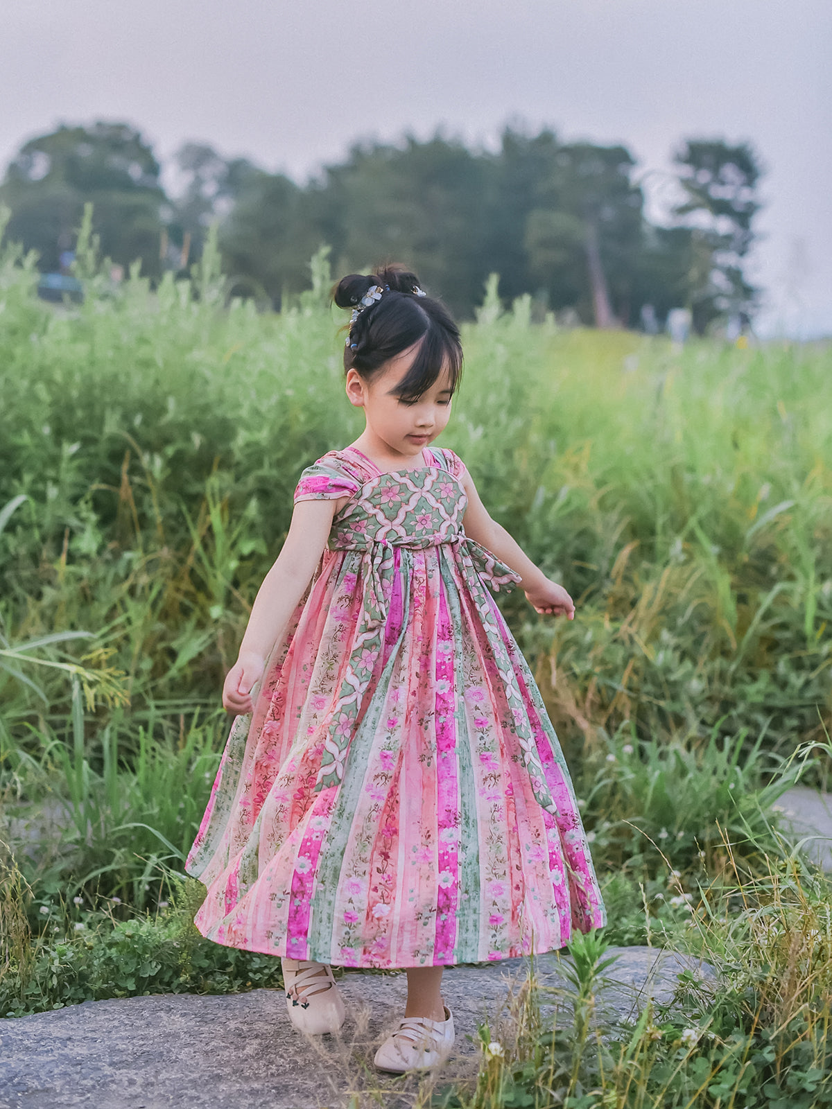 Girl wearing pink and green floral Hanfu-inspired dress, full front view