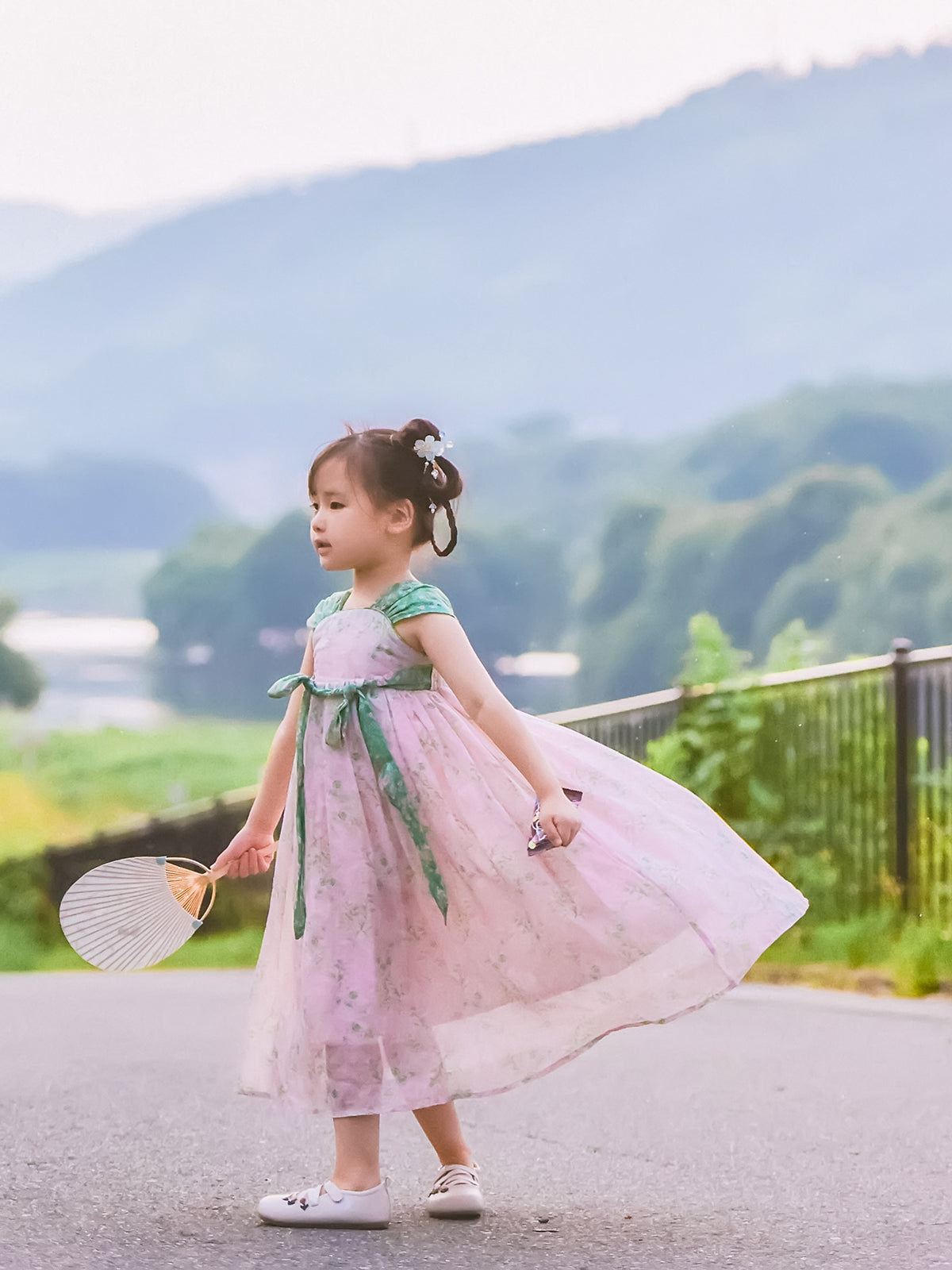 Girl wearing the Spring Blush blush pink and green Hanfu-inspired dress, full-length view