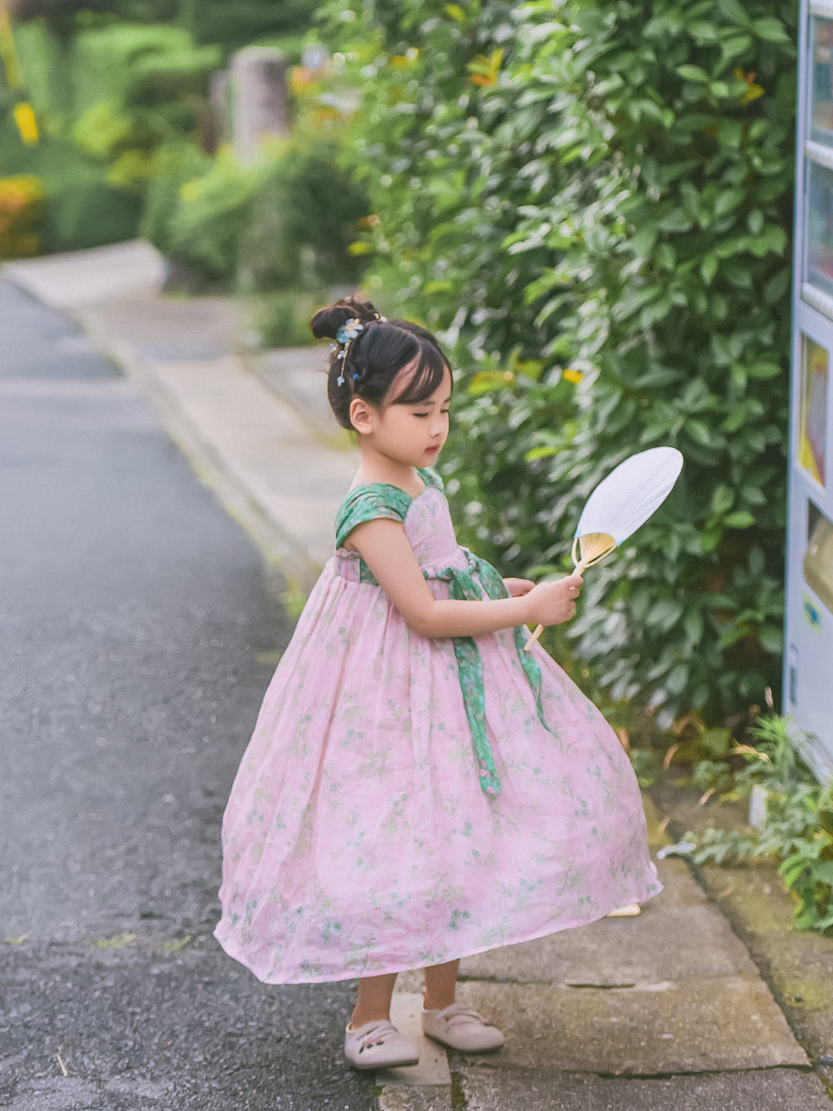 Girl wearing the Spring Blush Hanfu-inspired dress with an adjustable sash